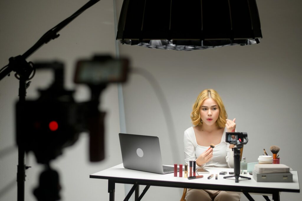 Behind the scenes young blonde woman entrepreneur working with laptop